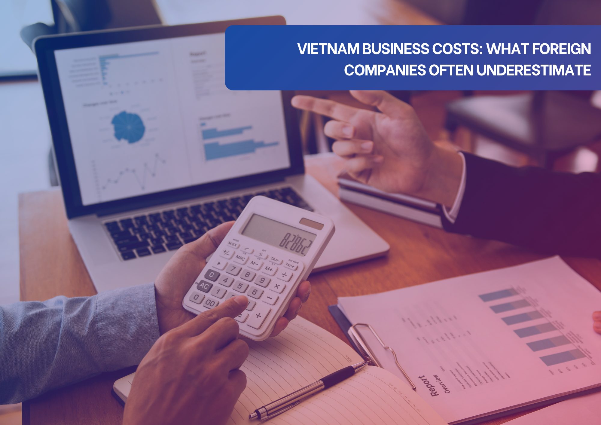 Vietnam Business Costs What Foreign Companies Often Underestimate Business professionals reviewing financial reports and calculating business costs in Vietnam.